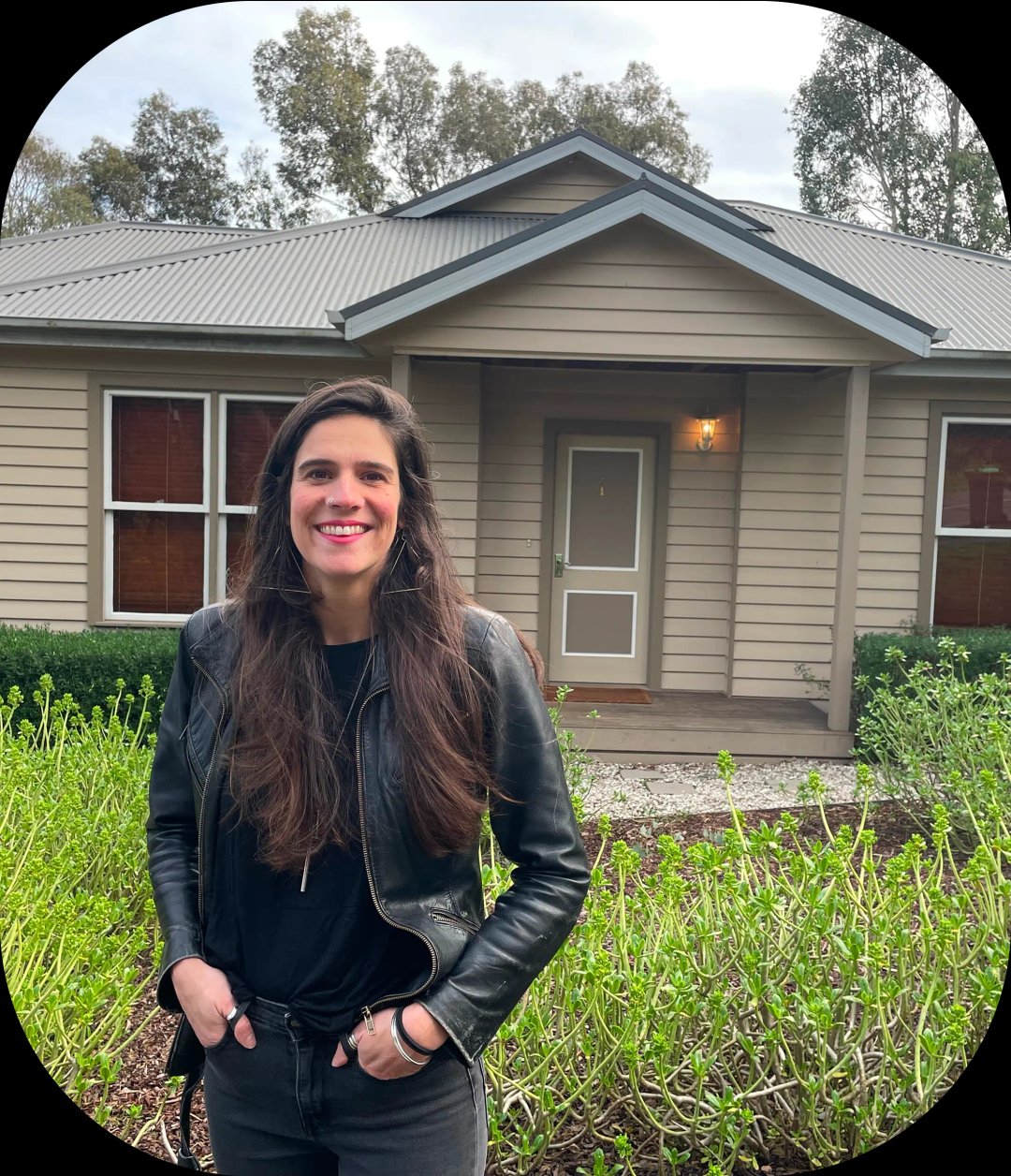 Ana is standing in front of a home.