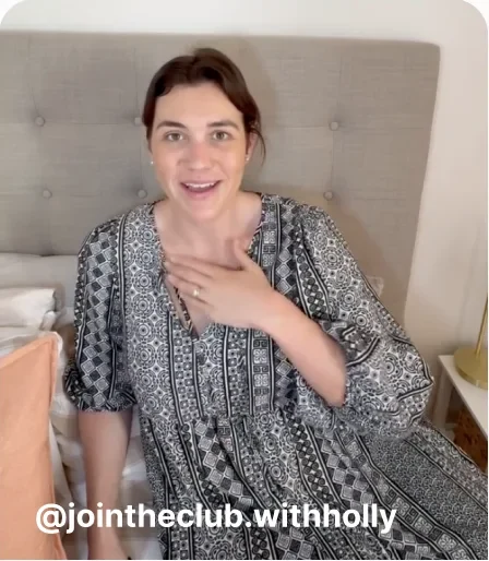 Woman sitting on a bed talking to the camera