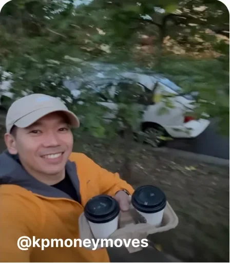 Man smiling holding two coffees