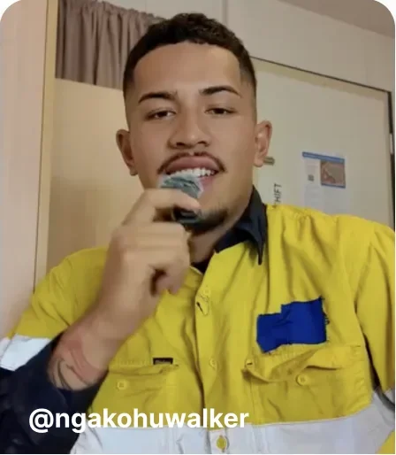 Man in hi-vis workwear talking into a microphone